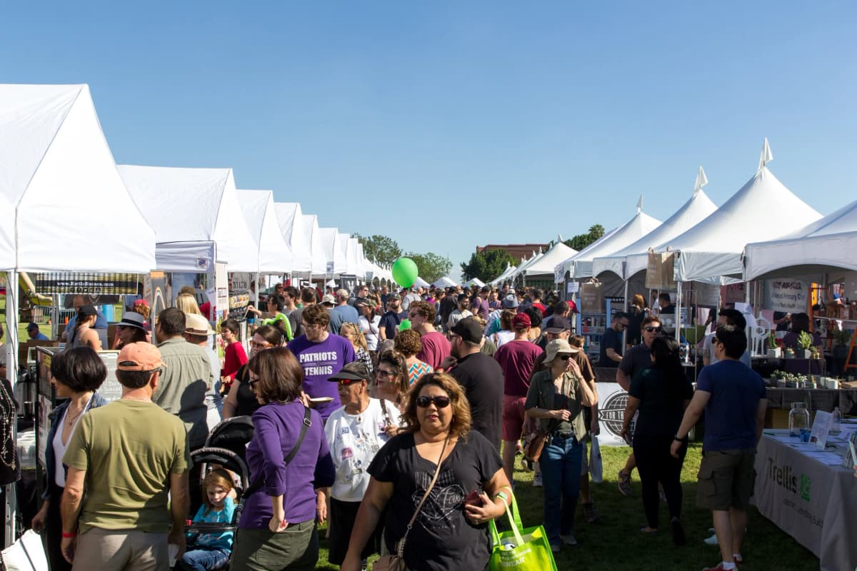 Vendors at a busy outdoor craft market