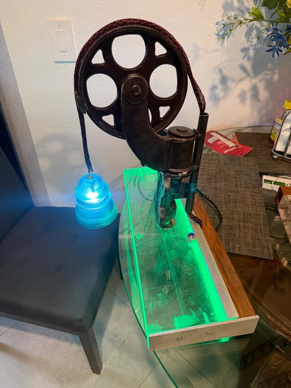Vintage industrial sculpture transformed into illuminated functional art.
